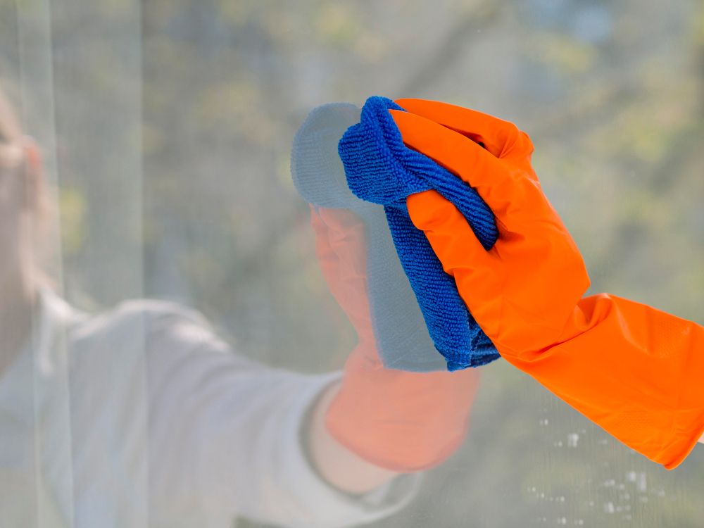 close-up-cleaning-window-with-cloth-compressed.jpg